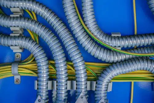 Isolation of wires in a metal corrugation on a blue background